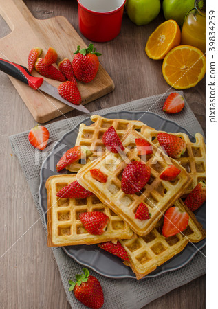 Homemade waffles with maple syrup and strawberries 39834259