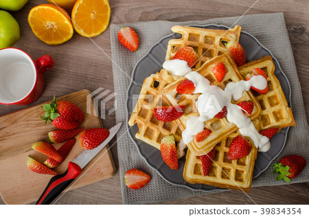 Homemade waffles with maple syrup and strawberries 39834354