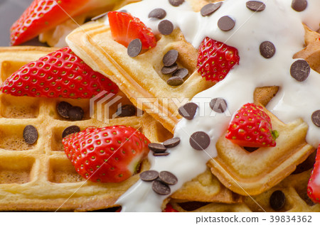 Homemade waffles with maple syrup and strawberries Homemade waffles with maple syrup and strawberries 39834362