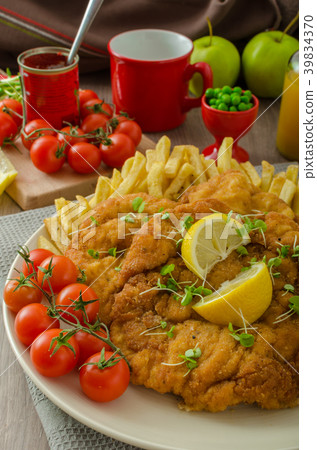 Schnitzel, french fries and microgreens salad 39834370