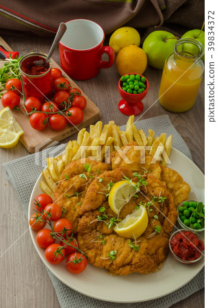 Schnitzel, french fries and microgreens salad 39834372