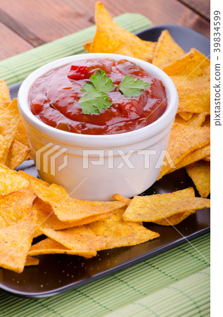 Tortilla chips with spicy tomato salsa 39834599