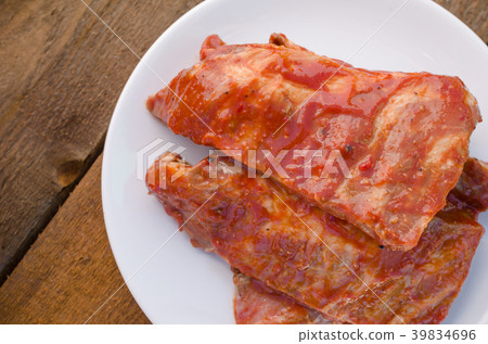Spareribs on grill with hot marinade 39834696