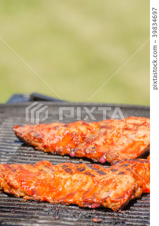 Spareribs on grill with hot marinade Spareribs on grill with hot marinade 39834697