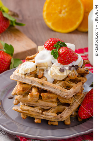 Belgian waffles with chocolate chips and fruits Belgian waffles with chocolate chips and fruits 39836344
