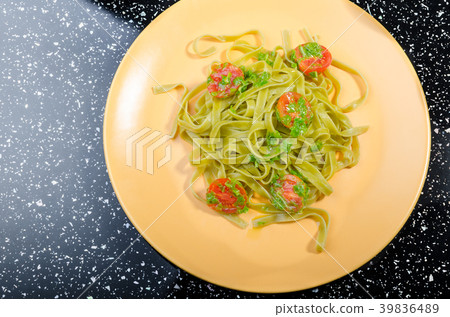 Pasta with basil pesto and pine nuts, cherry tomatoes 39836489