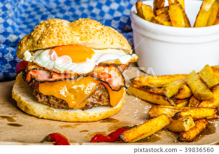 Homemade burger with fried egg and spicy fries 39836560