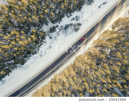 Snowy road with a moving car in winter Snowy road with a moving car in winter 39841994
