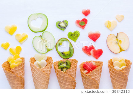 Various fruits in waffle cones and heart shape. Various fruits in waffle cones and heart shape. 39842313