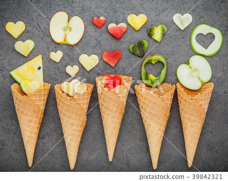 Various fruits in waffle cones  and heart shape. 39842321