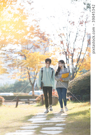 College students couple on fall campus College students couple on fall campus 39845342