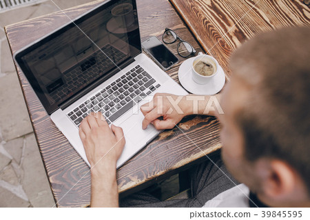 man with laptop in cafe man with laptop in cafe 39845595