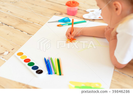 Little blonde girl painting on big white paper 39846286