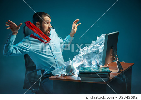 Young stressed handsome businessman working at Young stressed handsome businessman working at 39849692