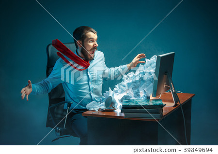 Young stressed handsome businessman working at Young stressed handsome businessman working at 39849694
