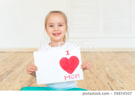 Little girl paints greeting card for Mom 39854507