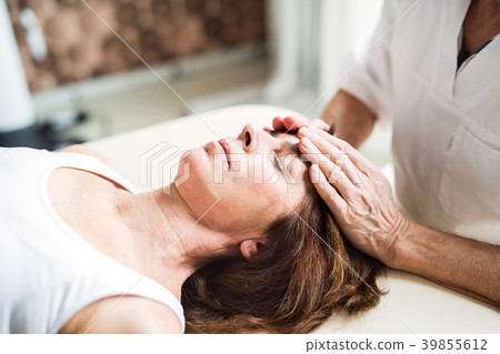 A physiotherapist working with a female patient. A physiotherapist working with a female patient. 39855612