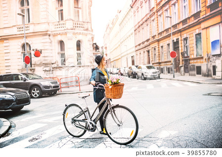 Young woman with bicycle in sunny spring town. Young woman with bicycle in sunny spring town. 39855780