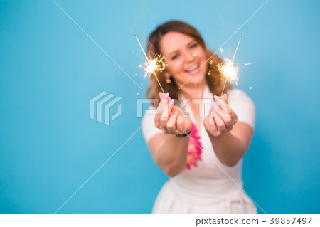 Young happy woman with sparklers celebrate and Young happy woman with sparklers celebrate and 39857497