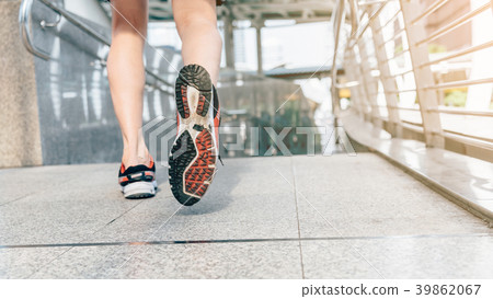 Athlete runner feet running in the city closeup Athlete runner feet running in the city closeup 39862067