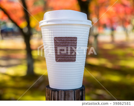 Paper beverage cup under autumn trees Paper beverage cup under autumn trees 39862581