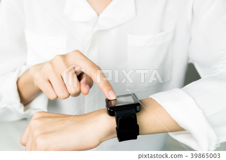 Woman touch screen digital clock in the display. 39865003