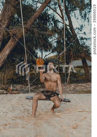 Handsome man siting on the swing with pandan Handsome man siting on the swing with pandan 39866019