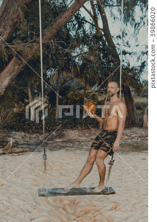 Handsome man standing on the swing with pandan Handsome man standing on the swing with pandan 39866020