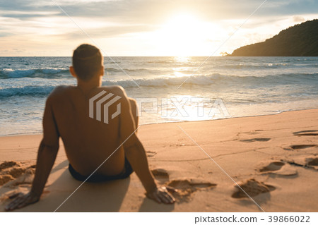 Man siting at the lazy beach and enjoying sunset Man siting at the lazy beach and enjoying sunset 39866022