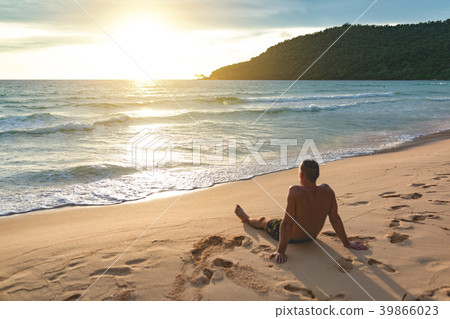 Man siting at the lazy beach and enjoying sunset Man siting at the lazy beach and enjoying sunset 39866023