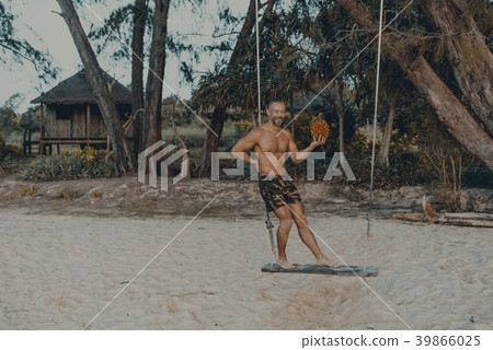 Handsome man standing on the swing with pandan Handsome man standing on the swing with pandan 39866025