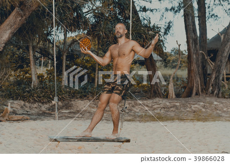 Handsome man standing on the swing with pandan Handsome man standing on the swing with pandan 39866028