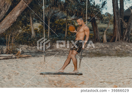 Handsome man standing on the swing with pandan Handsome man standing on the swing with pandan 39866029