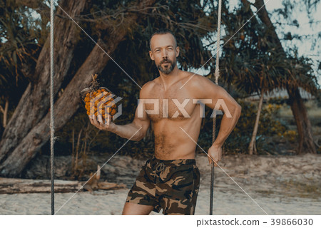 Handsome man standing on the swing with pandan Handsome man standing on the swing with pandan 39866030