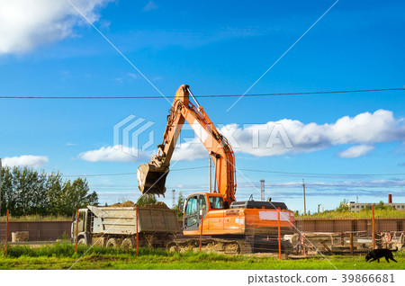 Excavator bucket loads heavy truck with ground 39866681