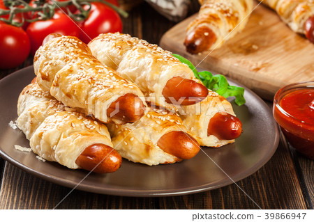 Rolled hot dog sausages baked in puff pastry 39866947