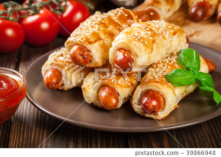 Rolled hot dog sausages baked in puff pastry 39866948