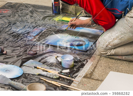 Unknown artist paints a picture on the street Unknown artist paints a picture on the street 39868282
