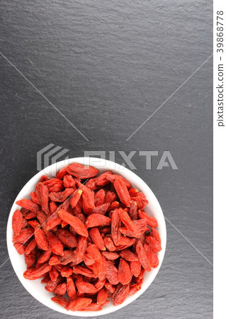 dried goji berries in a small white bowl 39868778