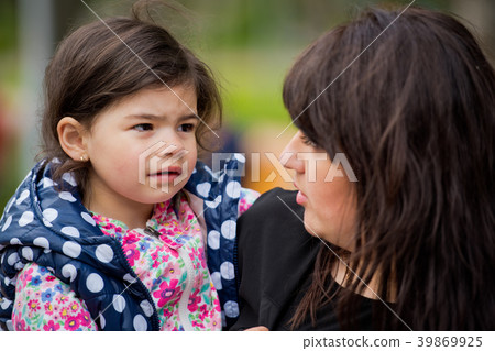 A small daughter in her mother's arms. A small daughter in her mother's arms. 39869925