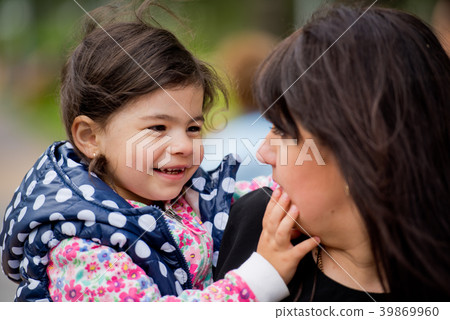 A little daughter in her mother's arms. A little daughter in her mother's arms. 39869960