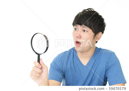 A man with a magnifying glass 39870579
