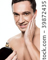 Handsome man using perfume isolated.  39872435