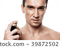 Handsome man using perfume isolated. Beauty man  39872502