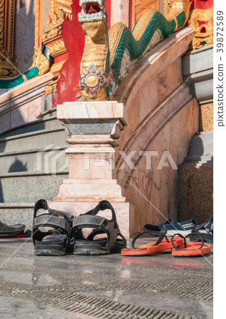 Shoes left at the entrance to the Buddhist temple. 39872589
