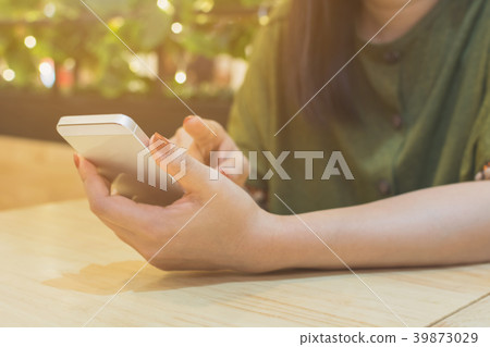 Asian women using smartphone in restaurant 39873029