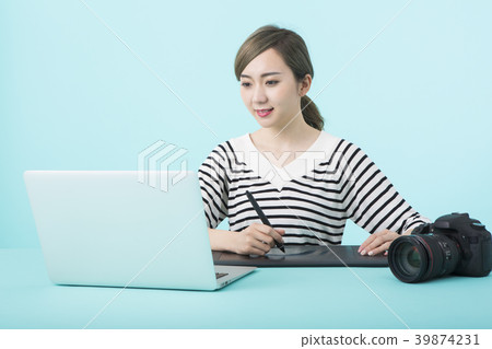 Woman doing retouch work with pen tab Woman doing retouch work with pen tab 39874231
