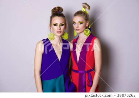 Two models with colorful make up and clothes Two models with colorful make up and clothes 39876262