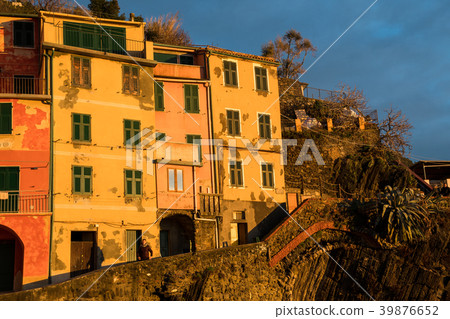 Riomaggiore illuminated by the setting sun of Cinque Terre (Liguria, Italy) Riomaggiore illuminated by the setting sun of Cinque Terre (Liguria, Italy) 39876652