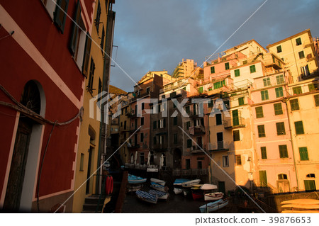 Riomaggiore illuminated by the setting sun of Cinque Terre (Liguria, Italy) Riomaggiore illuminated by the setting sun of Cinque Terre (Liguria, Italy) 39876653